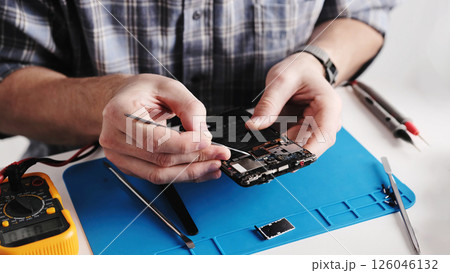 Service Technician Fixing Broken Smartphone In Service Center 126046132