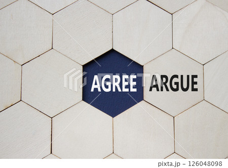 Agree or Argue symbol. Concept word Agree or Argue on wooden comb puzzle. Beautiful deep blue background. Business and Agree or Argue concept. Copy space 126048098