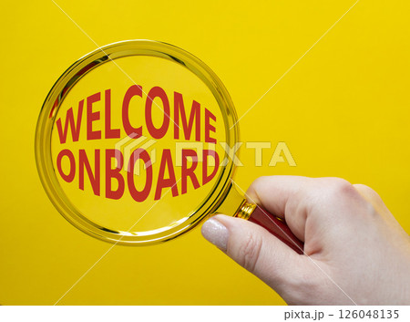 Welcome onboard symbol. Magnifying Glass with Concept word Welcome onboard. Businessman hand. Beautiful yellow background. Business and Welcome onboard concept. Copy space Welcome onboard symbol. Magnifying Glass with Concept word Welcome onboard. Businessman hand. Beautiful yellow background. Business and Welcome onboard concept. Copy space 126048135