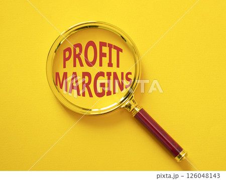 Profit Margins symbol. Magnifying glass with words Profit Margins. Beautiful yellow background. Business and Profit Margins concept. Copy space. 126048143