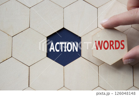Action or words symbol. Concept word Action or words on wooden comb puzzle. Businessman hand. Beautiful deep blue background. Business and Action or words concept. Copy space Action or words symbol. Concept word Action or words on wooden comb puzzle. Businessman hand. Beautiful deep blue background. Business and Action or words concept. Copy space 126048148