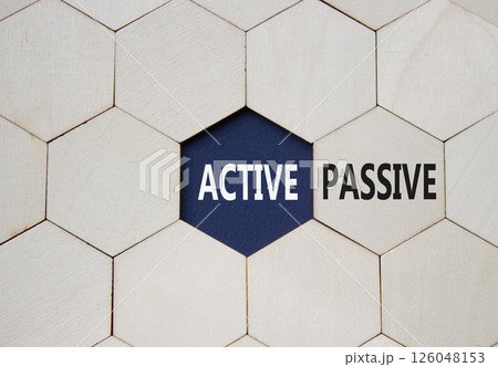 Active or Passive symbol. Concept word Active or Passive on wooden comb puzzle. Beautiful deep blue background. Business and Active or Passive concept. Copy space 126048153