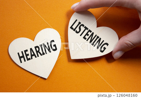 Growth and Stability symbol. Concept word Growth and Stability on wooden hearts. Businessman hand. Beautiful orange background. Business and Growth and Stability concept. Copy space 126048160