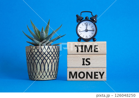 Time is Money symbol. Concept words Time is Money on wooden blocks. Beautiful blue background with alarm clock and succulent plant. Business and Time is Money concept. Copy space Time is Money symbol. Concept words Time is Money on wooden blocks. Beautiful blue background with alarm clock and succulent plant. Business and Time is Money concept. Copy space 126048250