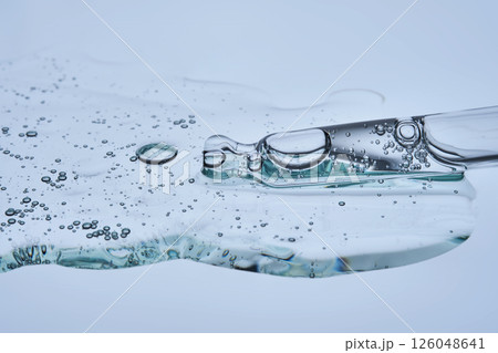 A facial serum with microneedles and a pipette on a blue background. The texture. 126048641