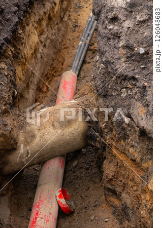 Repair of sewage heating systems or electricity. A trench has been dug in the ground. Repair of sewage heating systems or electricity. A trench has been dug in the ground. 126048683