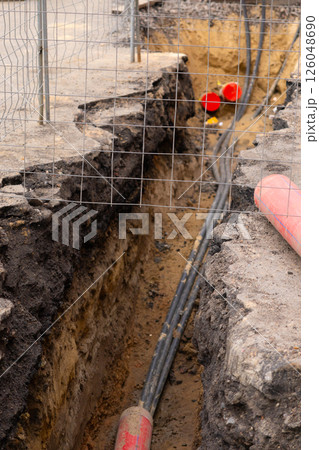 Repair of sewage heating systems or electricity. A trench has been dug in the ground. Repair of sewage heating systems or electricity. A trench has been dug in the ground. 126048690