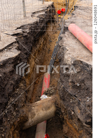 Repair of sewage heating systems or electricity. A trench has been dug in the ground. Repair of sewage heating systems or electricity. A trench has been dug in the ground. 126048691