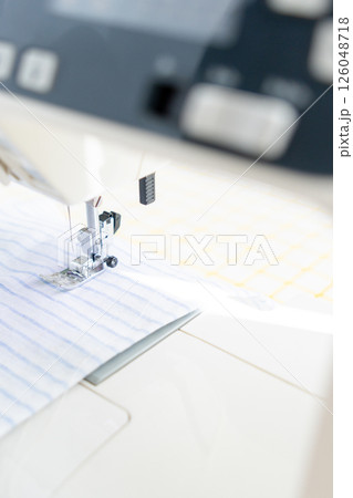 sewing machine with a cloth under a steel needle. manufacture of clothing. sewing machine with a cloth under a steel needle. manufacture of clothing. 126048718