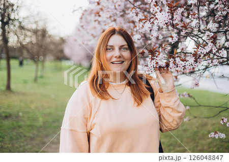 Portrait of a woman in a cherry blossom. Free outdoor recreation, spring blooming garden Portrait of a woman in a cherry blossom. Free outdoor recreation, spring blooming garden 126048847