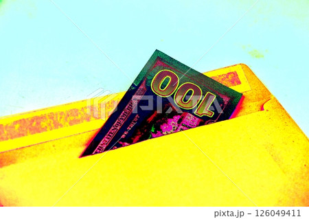 Close-up of an envelope with a hundred dollar bill. Changed color scheme. Close-up of an envelope with a hundred dollar bill. Changed color scheme. 126049411