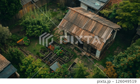 Old rustic cottage surrounded by lush garden 126049519