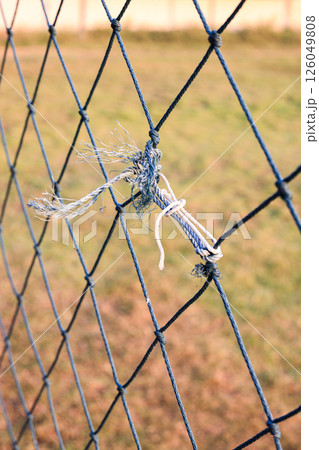 Rope knots are used to repair weathered and tangled green nets. Rope knots are used to repair weathered and tangled green nets. 126049808