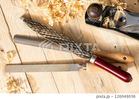 Flat lay of s Set of Rasps lying on wooden planks in a carpentry workshop Flat lay of s Set of Rasps lying on wooden planks in a carpentry workshop 126049836