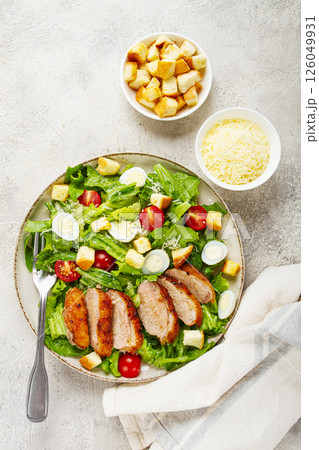 Caesar salad, with duck breast, on a light plate, on a light background, homemade, no people, 126049931