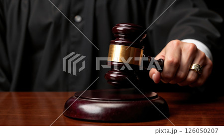 Judge's gavel striking sound block in a courtroom ruling 126050207