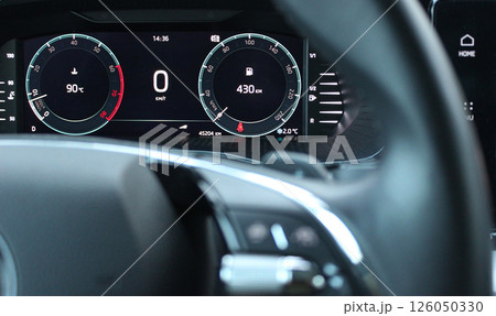 Engine operating temperature and remaining mileage before refueling at the instrument cluster on LED car dashboard Engine operating temperature and remaining mileage before refueling at the instrument cluster on LED car dashboard 126050330
