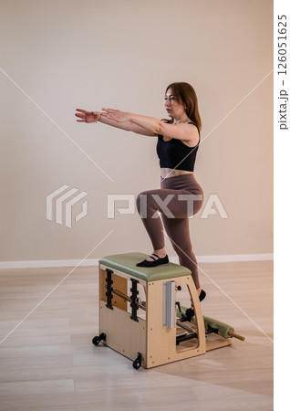 Asian woman doing pilates classic chair.  126051625