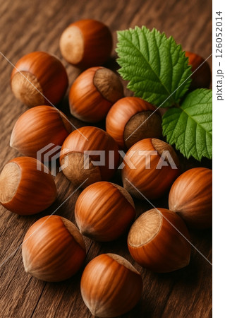 Hazelnuts Gathered on a Wooden Surface With Green Leaves in a Natural Setting 126052014
