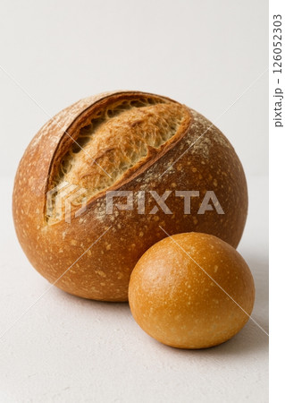 Freshly Baked Bread Loaf and Roll on a Plain Background in Natural Light 126052303