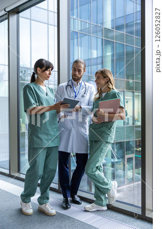 Doctors discussing an interesting case and looking involved 126052827