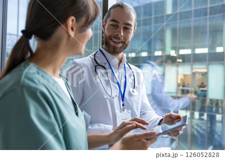 Doctors discussing an interesting case and looking involved Doctors discussing an interesting case and looking involved 126052828