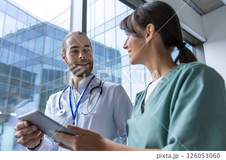 Doctors discussing an interesting case and looking involved 126053060