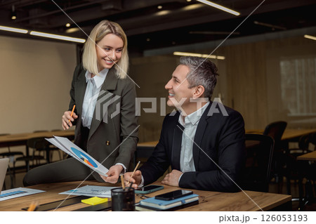 Two colleagues discussing project details and feeling positive Two colleagues discussing project details and feeling positive 126053193