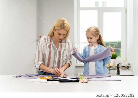 Blonde woman tailoring a new model in her design studio 126053282