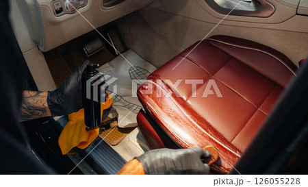 Car wash worker doing detailing, cleaning car salon Car wash worker doing detailing, cleaning car salon 126055228