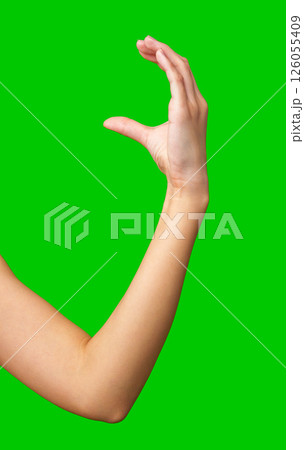 Hand gesture demonstrating the symbol of good luck on a bright green background Hand gesture demonstrating the symbol of good luck on a bright green background 126055409