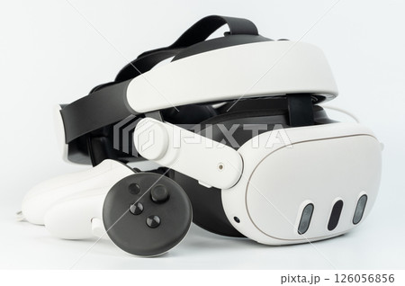 Modern VR headset and controller showcasing advanced technology on clean surface Modern VR headset and controller showcasing advanced technology on clean surface 126056856