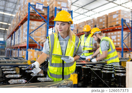 Female professional worker uses bar code reader scanning quality checking car parts in warehouse. Supervisor import-export shipping transportation, logistic business factory concept. Female professional worker uses bar code reader scanning quality checking car parts in warehouse. Supervisor import-export shipping transportation, logistic business factory concept. 126057373
