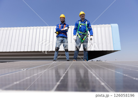 Engineer set installation and inspection standards of solar panels on roof of an industrial factory. Team technician inspection solar cell. Alternative innovation power environmental. Engineer set installation and inspection standards of solar panels on roof of an industrial factory. Team technician inspection solar cell. Alternative innovation power environmental. 126058196
