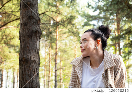 Woman Enjoying Sunny Day in a Pine Forest. Concept of Walking in Nature, Freedom and Tranquility. Woman Enjoying Sunny Day in a Pine Forest. Concept of Walking in Nature, Freedom and Tranquility. 126058216