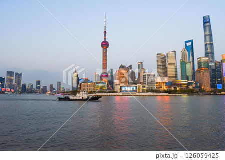 Shanghai, China - 1 April 2025: Tourist boat passes along the Bund waterfront in front of Pudong skyline featuring Oriental Pearl Tower and Shanghai Tower Shanghai, China - 1 April 2025: Tourist boat passes along the Bund waterfront in front of Pudong skyline featuring Oriental Pearl Tower and Shanghai Tower 126059425