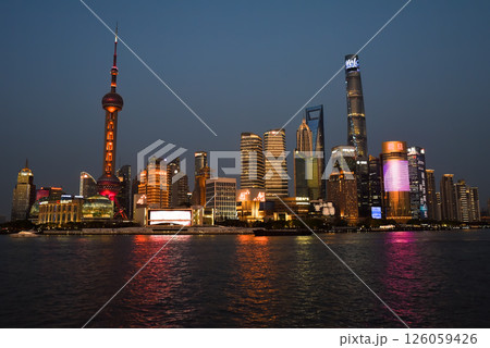 Shanghai, China - 1 April 2025: Evening view of Pudong skyline from the Bund with Oriental Pearl Tower and Shanghai Tower lit against the twilight sky 126059426