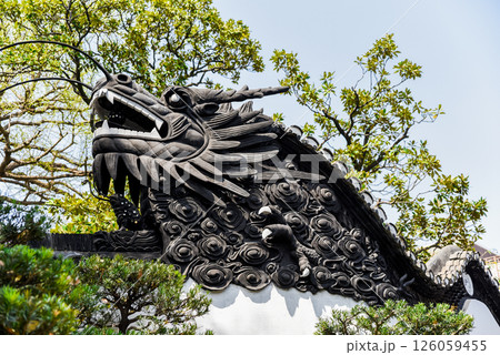 Shanghai, China - 1 April 2025: Dragon carving on the tiled roof of yuyuan garden, symbol of Chinese culture, harmony and classic garden design Shanghai, China - 1 April 2025: Dragon carving on the tiled roof of yuyuan garden, symbol of Chinese culture, harmony and classic garden design 126059455