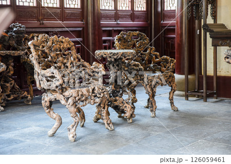 Shanghai, China - 1 April 2025: Interior view of He Xu Hall featuring sculptural chairs made from banyan roots in Dianchun Hall, Yuyuan Garden Shanghai, China - 1 April 2025: Interior view of He Xu Hall featuring sculptural chairs made from banyan roots in Dianchun Hall, Yuyuan Garden 126059461