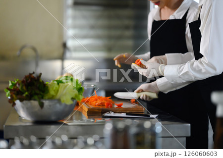 Culinary students washing produce in a cooking school 126060603