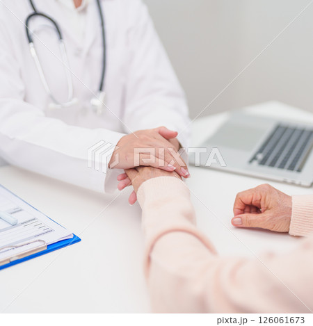 doctor holding hands with elderly female patient, showing empathy and support during a medical consultation. trust, Senior and geriatric care, healthcare, Mental Health, giving advice and emotional doctor holding hands with elderly female patient, showing empathy and support during a medical consultation. trust, Senior and geriatric care, healthcare, Mental Health, giving advice and emotional 126061673