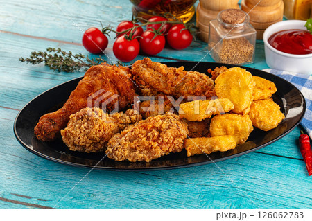 Golden crispy fried chicken mix - wings, drumsticks, nuggets and strips Golden crispy fried chicken mix - wings, drumsticks, nuggets and strips 126062783