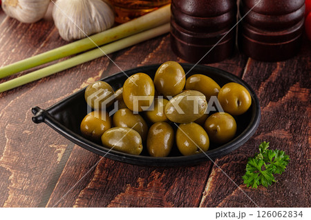 Greek green olives marinated in the bowl 126062834