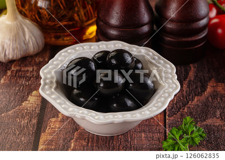 Mediterranean marinated Black olives in the bowl 126062835
