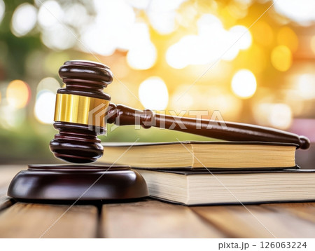 Judge gavel resting on law books symbolizing justice and legal proceedings 126063224