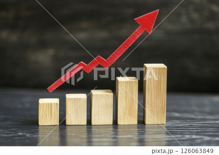 Red arrow pointing upwards, showing growth and success on wooden blocks chart 126063849