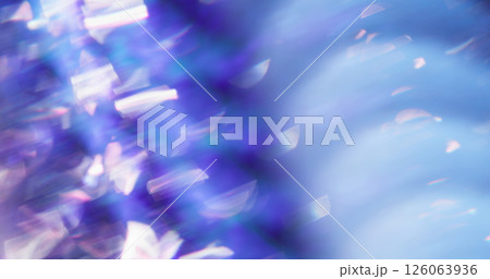 Crystal light. Blurred gleaming particles. White sparkling lens flare turning on blue purple smoky bokeh art background. Crystal light. Blurred gleaming particles. White sparkling lens flare turning on blue purple smoky bokeh art background. 126063936