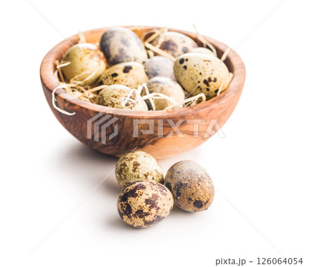 Spotted quail eggs in bowl isolated on white background. Spotted quail eggs in bowl isolated on white background. 126064054
