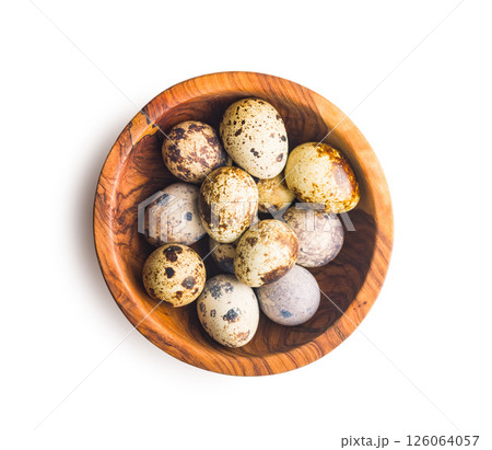 Spotted quail eggs in bowl isolated on white background. 126064057