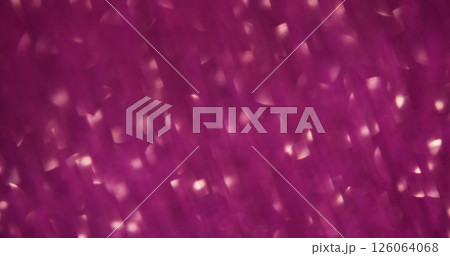 Bokeh glow. Defocused light. Gleaming lens flare on blurred pink color kaleidoscope luminous art gleam background. 126064068